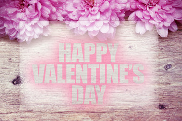 pink flowers on wooden with word Happy Valentine's Day