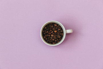 Stylish set: cup of coffee beans on pastel backgrounds. Flat lay. Top view.