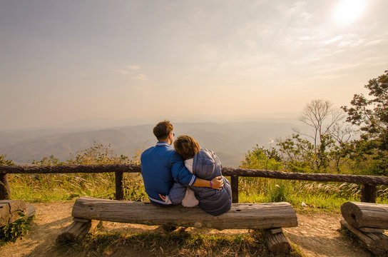 Happy family cliffside looking sunrise. Young couple have romantic, at Doi Samer Dao (Na Noi, Nan province in Thailand)