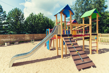 climbing frame with slide on playground at summer