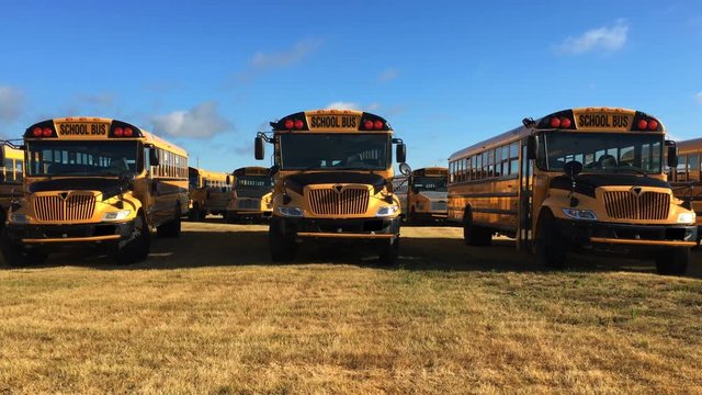 4K UltraHD A Close view of parked schoolbuses