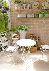 terrace or balcony with small table, chair and flowers