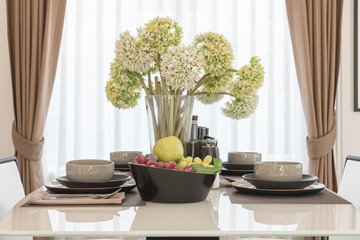 table set on dining table with vase of flower