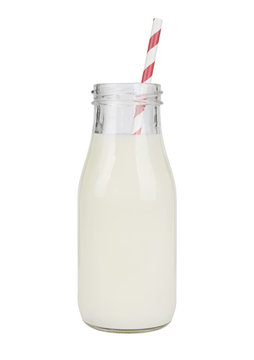 A vintage style glass bottle of milk with straw isolated on a white background