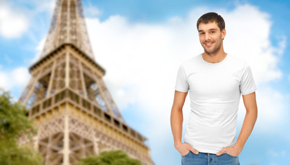 happy man in blank white t-shirt over eiffel tower