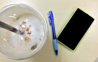 Soft Focus : coffee with phone and pen on table : Focus on Coffe