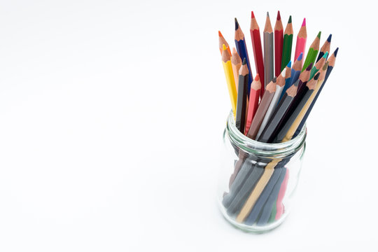 Colorful pencils in bottle on white background