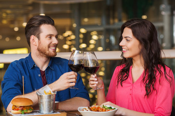 happy couple dining and drink wine at restaurant