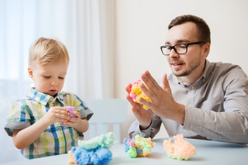 father and son playing with ball clay at home