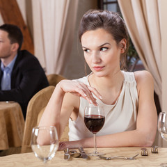 Woman drinking wine in a restaurant