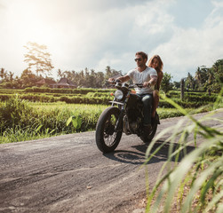 Obraz na płótnie Canvas Couple riding motorcycle on country road