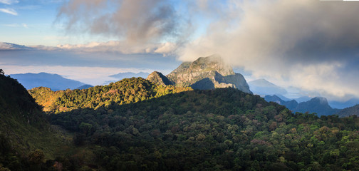 mountain peak and raining fog blue sky