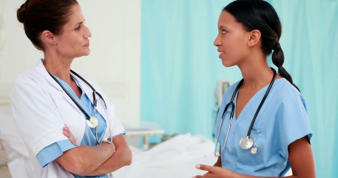 Two happy doctors speaking together 