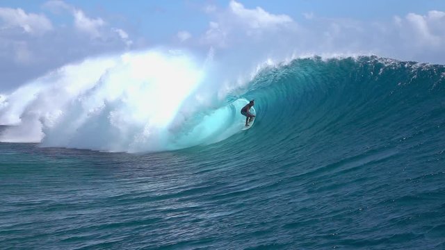 SLOW MOTION: Extreme surfer surfing inside big tube barrel wave