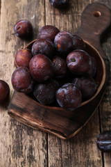 ripe plums on wooden vintage background