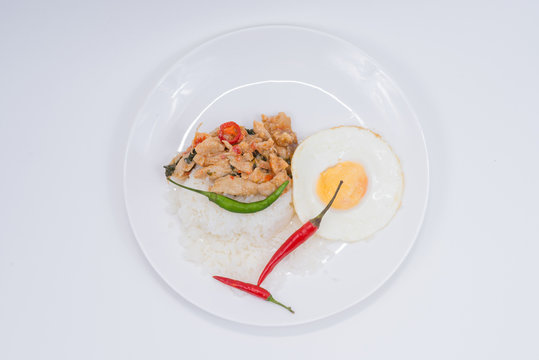 Stir-fried pork with rice , egg and pepper.