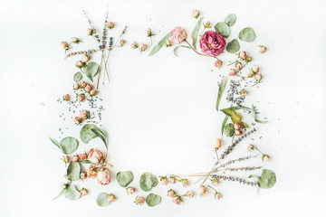 wreath frame with roses, lavender, branches, leaves and petals isolated on white background. flat lay, overhead view