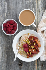 oatmeal with baked fruit and fresh coffee with milk 