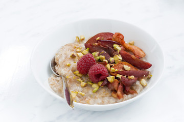 oatmeal with baked fruit on white table