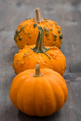 orange pumpkins on a wooden background, selective focus