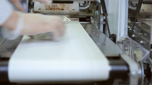 Conveyor line for packaging of cold snack for food on board plane.