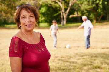 Happy Senior Grandma Playing Soccer With Family