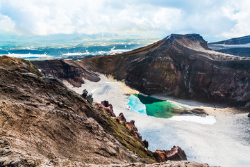 Lake in crater of the volcano Goreliy on Kamchatka, Russia