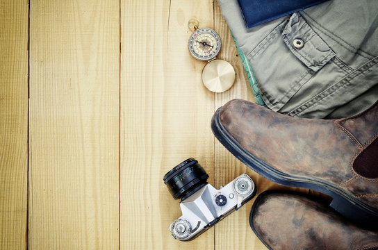 travel accessories over wooden background. retro style image