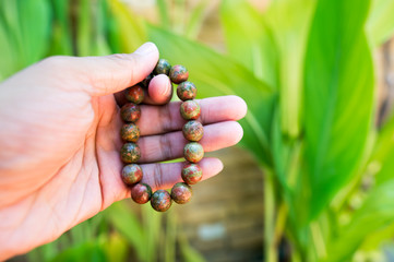 Hold sacred stone bracelet.