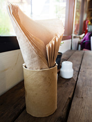 Fototapeta na wymiar Tissue paper in paper box on wooden table