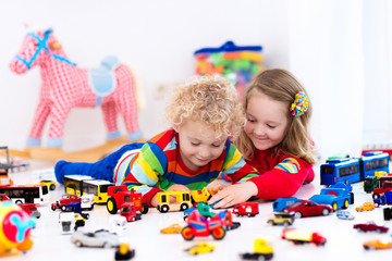 Fototapeta premium Little kids playing with toy cars