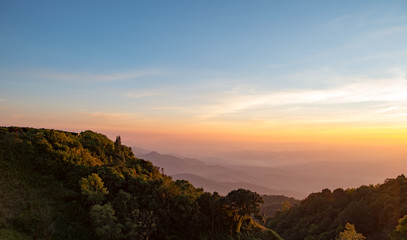 The orange light of the sun on the mountains.