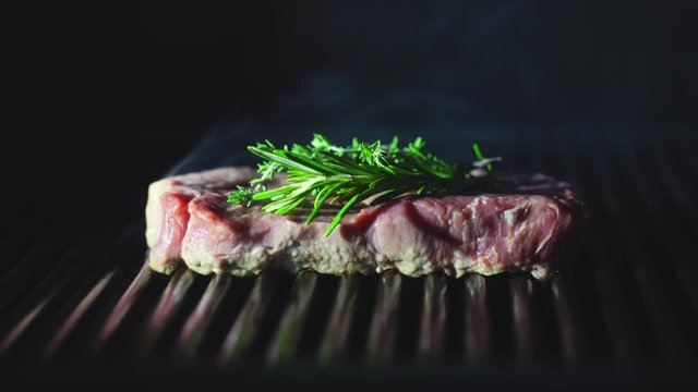 Raw beef steak on a grill