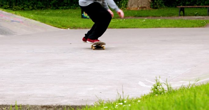 Young skateboarder skating the outdoor skatepark