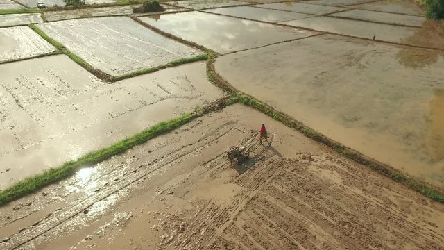 Thai farmer using walking tractor for cultivated soil for prepare plantation