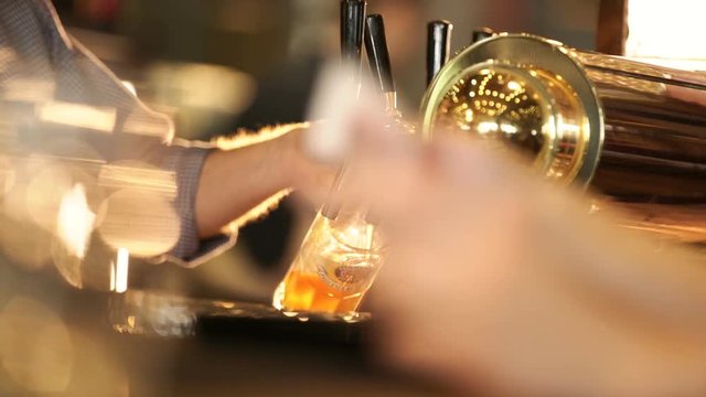 Brewer Pours Beer Into A Glass