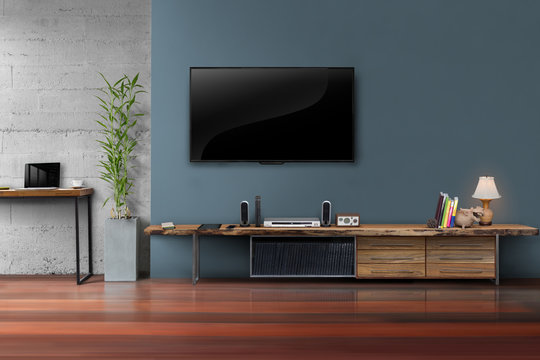 Living room led tv on dark blue wall with wooden table media fur