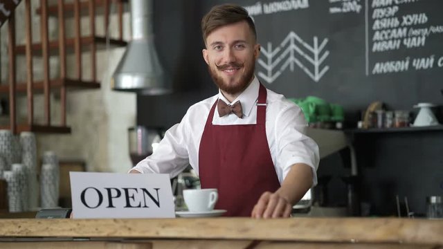 Smiling waiter at the counter