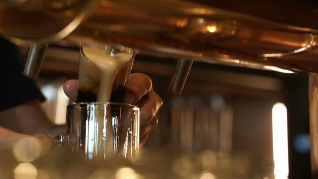 Brewer pours beer in a pub