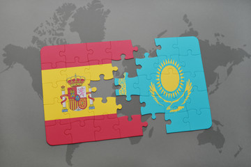 puzzle with the national flag of spain and kazakhstan on a world map background.