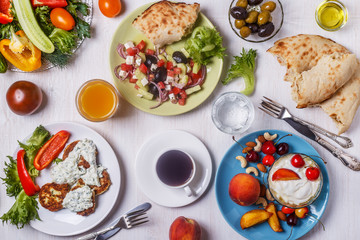 Greek appetizers  - fritters of zucchini, Greek salad, yogurt.