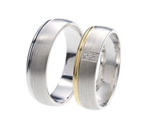 Two wedding rings standing next to each other 