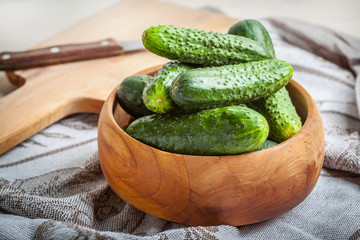 Fresh cucumbers in a wooden bowl.