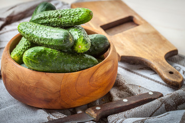 Fresh cucumbers in a wooden bowl.