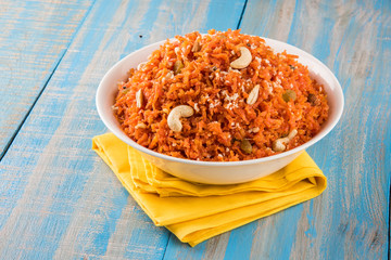 tasty gajar halwa or gajar ka halwa made up or fresh carrot, sugar and milk. decorated with almond or badam, cashewnuts and pistachios, favourite north indian dessert usually served in weddings - obrazy, fototapety, plakaty