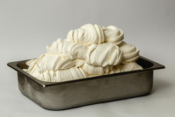 White ice cream in the metal tray on white background