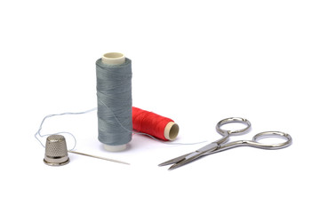 Needle, thimble, scissors, thread and knob isolated on white background