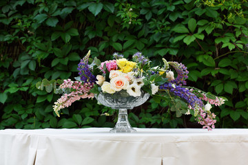 Beautiful flower bouquet outdoors. Wedding floristic decoration at white table
