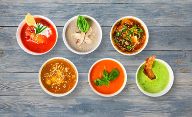 Variety of soups at blue wood, top view