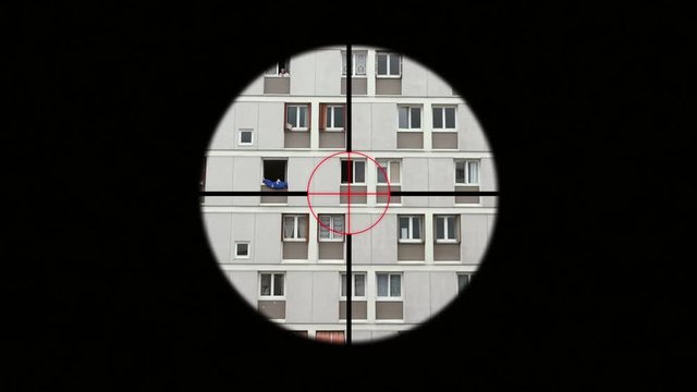 Sniper Rifle Aiming Person In Window, Telescopic Sight. A sniper rifle is a man-portable, high precision, shoulder-fired rifle designed to ensure more accurate shooting at longer ranges.